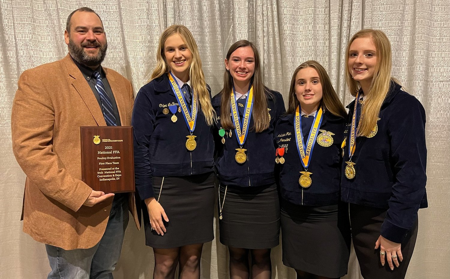 Taylor High School agricultural sciences teacher and Future Farmers of America coach David Laird (left) holds the plaque naming Taylor FFA as the national champions in poultry evaluation for 2021. He is accompanied by Taylor FFA poultry team members (from left to right) Chloe LaBard, Kristen Justilian, Madailein Fitch and Taylor FFA president Kathryn “Kacki” Kyrisch who each placed in the top five of individual events in addition to winning the overall team championship.